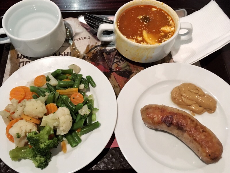 Steamed veggies, meat soup, and sausage with hot mustard
