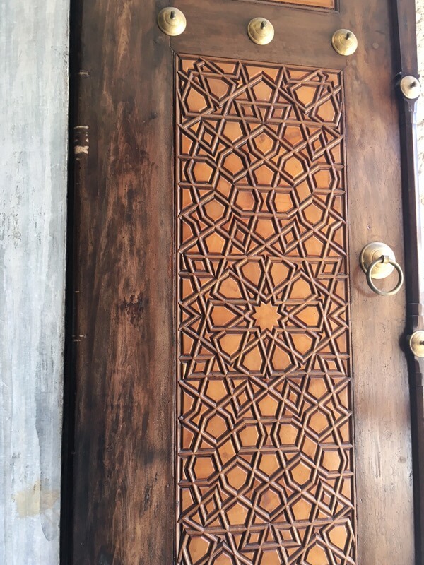 Geometric patterns on a tomb window shutter